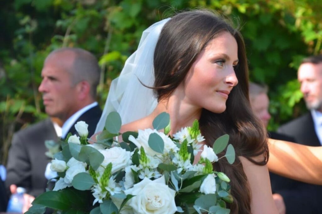 Taylor Savage providing bridal makeup on a wedding day