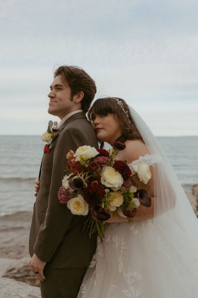 Couple surrounded by wedding florals by Mountain Blooms